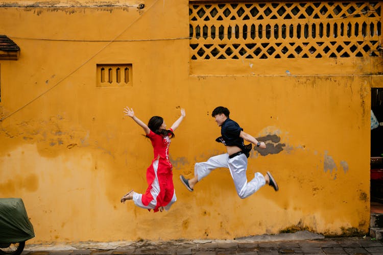 Photo Of A Couple Jumping Together