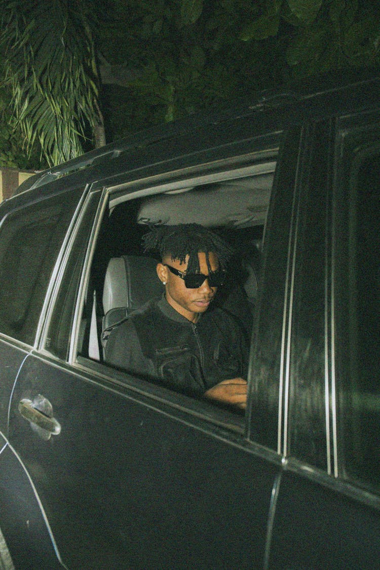 Man In Sunglasses In The Back Seat Of A Car