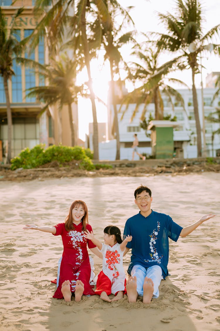 Mother. Father And Daughter Posing On Beach