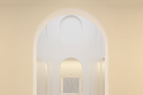 Arched Doorway Leading to White Room