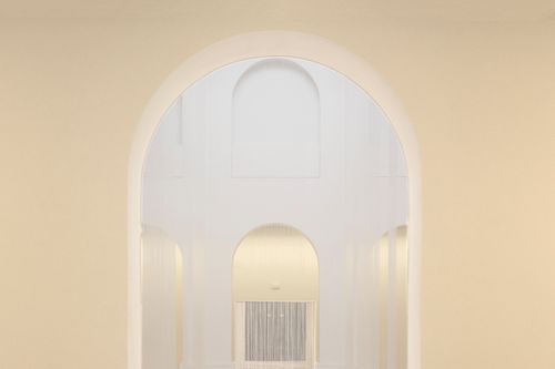 Free A bright and minimalist interior showcasing an elegant arched doorway leading into a serene white room. Stock Photo