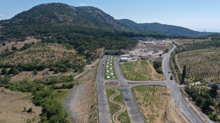 High Angle View Of Roads And A Tunnel In A Mountain Landscape