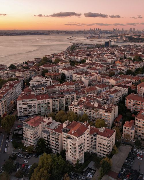 Free Aerial shot of Istanbul's coastal cityscape at sunset, showcasing urban architecture and the serene sea. Stock Photo