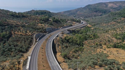 Free Scenic aerial shot of a winding highway through Küçükçetmi, Çanakkale, Turkey. Stock Photo