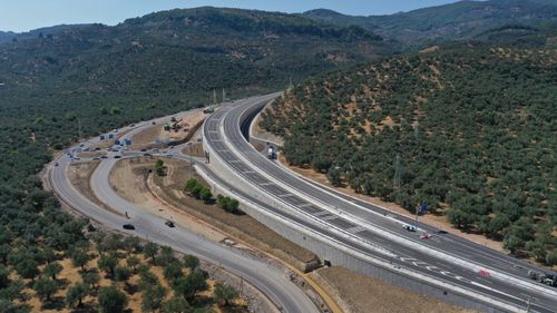Free Stunning aerial shot of a highway and surrounding landscape near Küçükkuyu, Turkey. Stock Photo