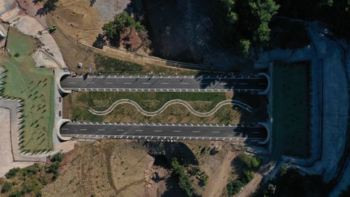 Free Drone shot of a dual carriageway bridge surrounded by natural landscape in Nusratlı, Çanakkale, Turkey. Stock Photo