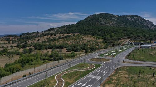 Free Aerial view of a highway with mountain backdrop in Yeniçam, Çanakkale, Turkey. Stock Photo