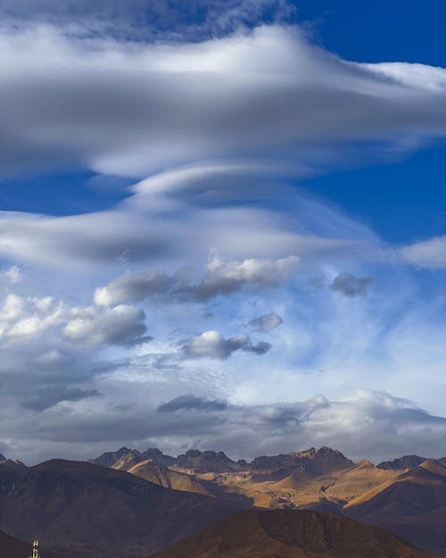 Fluffy White Clouds over Mountains