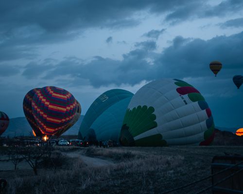 Free Hot air balloons preparing for flight at twilight, creating a picturesque adventure scene. Stock Photo