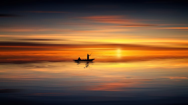 Photo Of People On Rowboat During Sunset