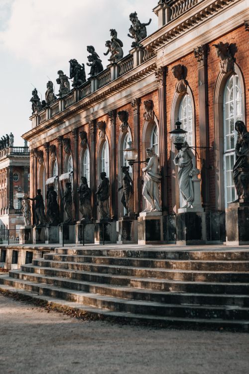 Free View of the ornate facade and sculptures of the New Palace in Potsdam's Sanssouci Park. Stock Photo