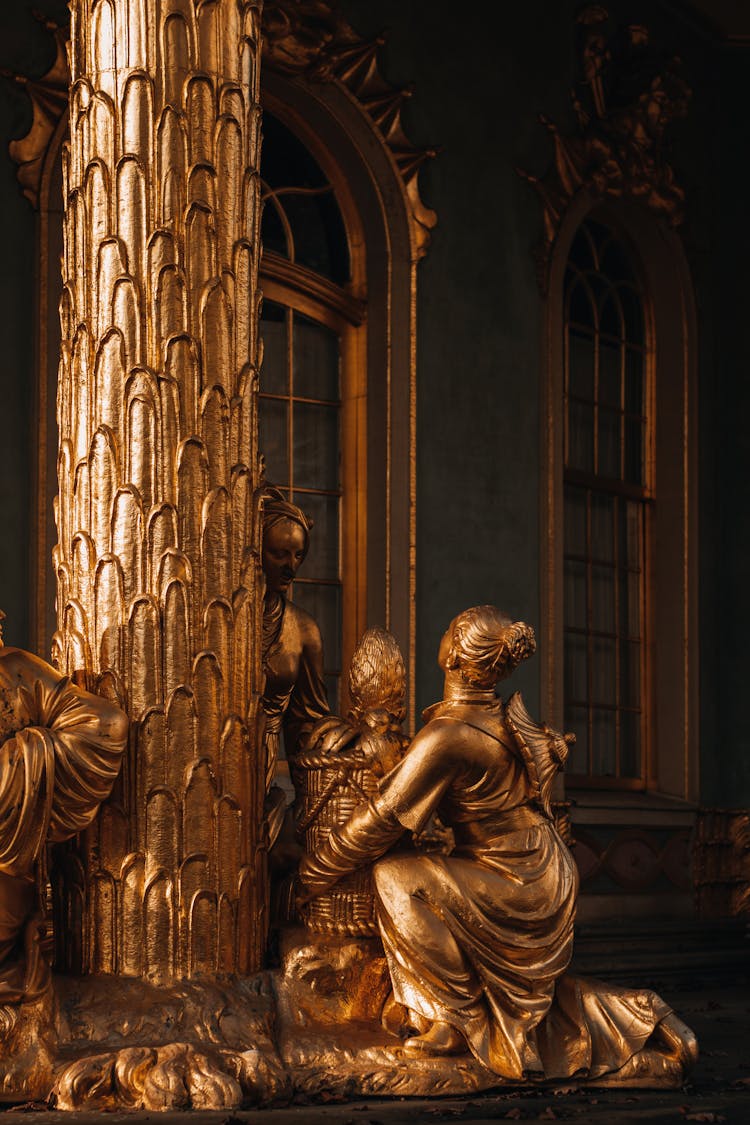 Golden Statues Beside A Window