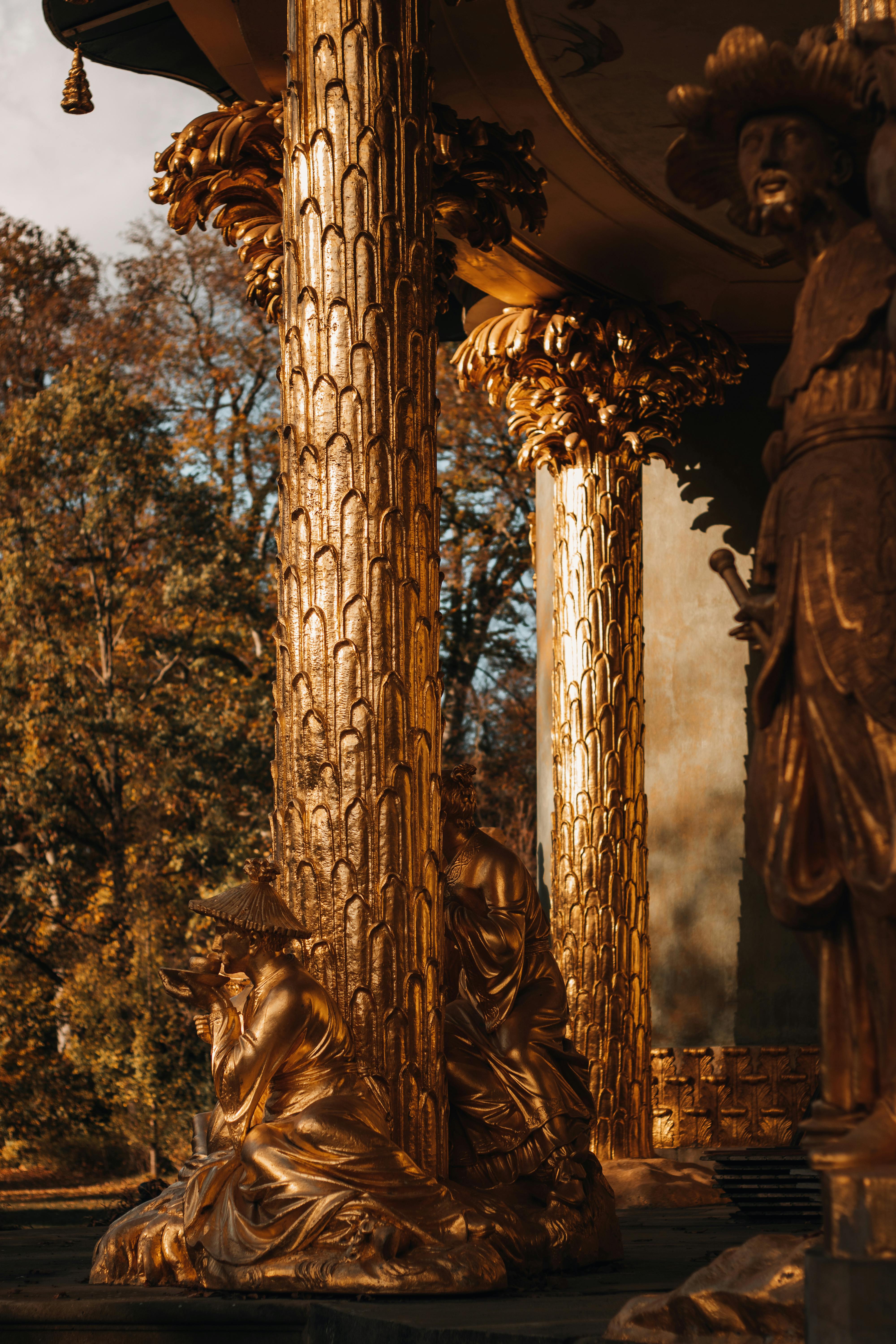 statues beside golden pillars