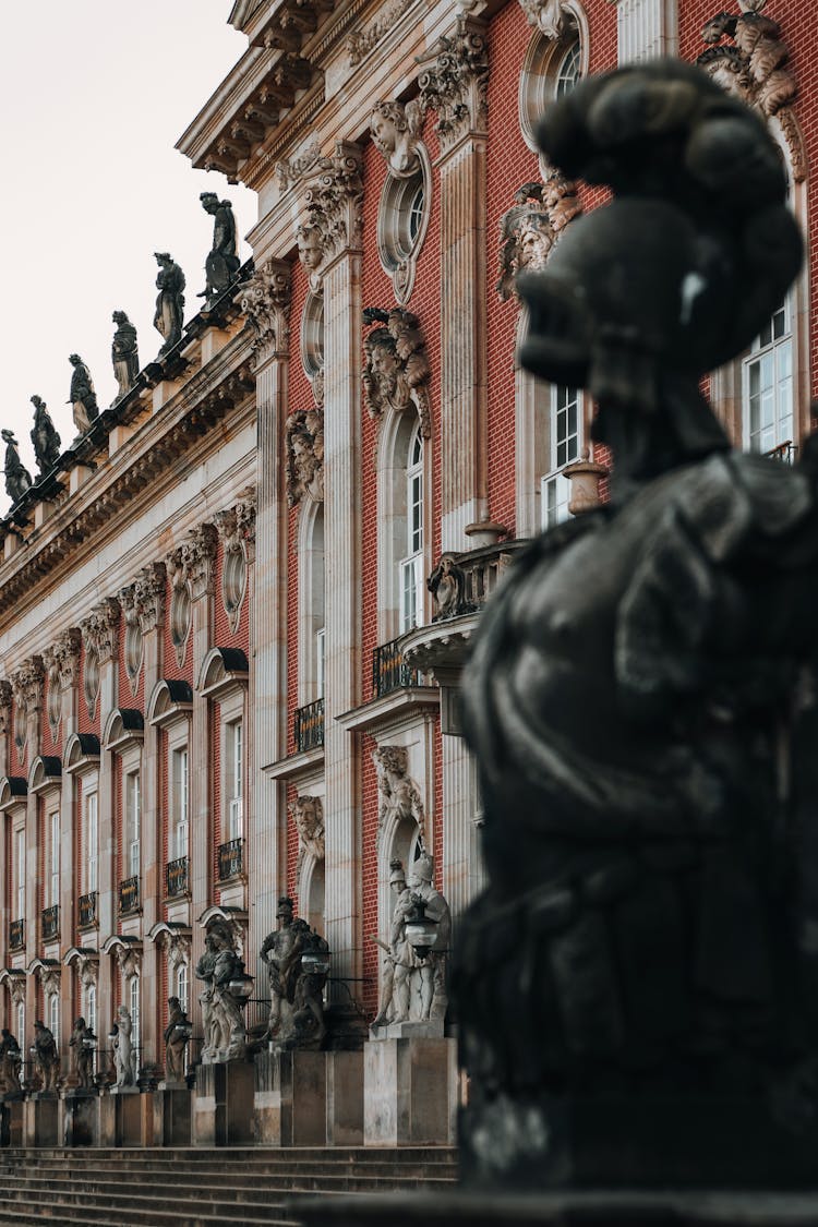 Black Statues Beside A Building