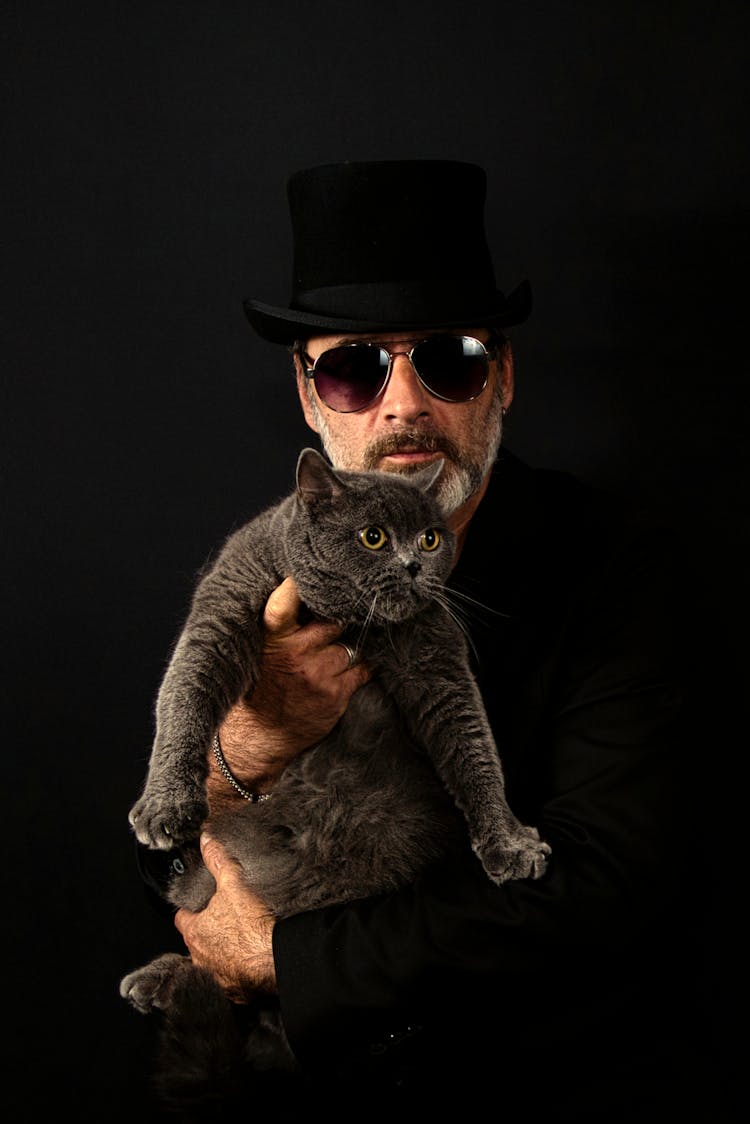 Man Wearing Glasses Holding British Shorthair Cat