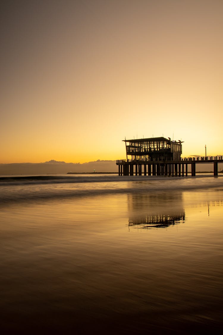 Golden Sunrise Over The Pier On Ushaka Beach In South Africa