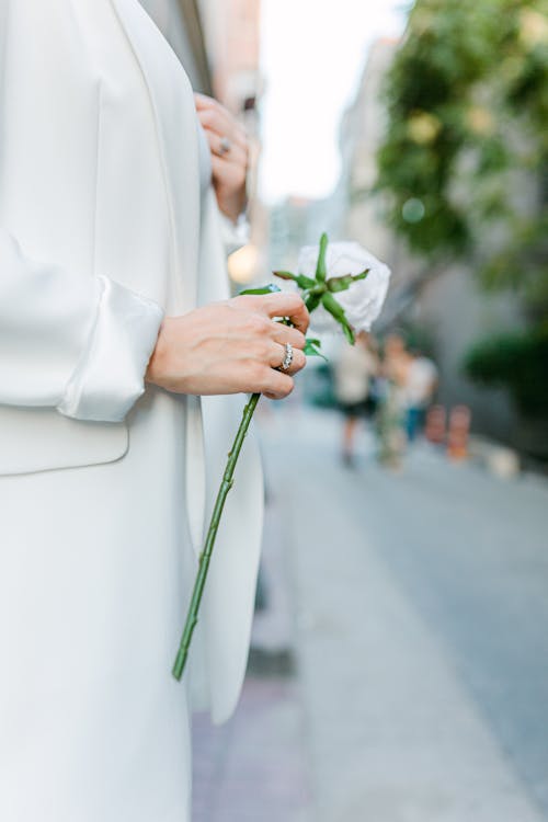 Close-up of Woman in Suit Holding Flower 