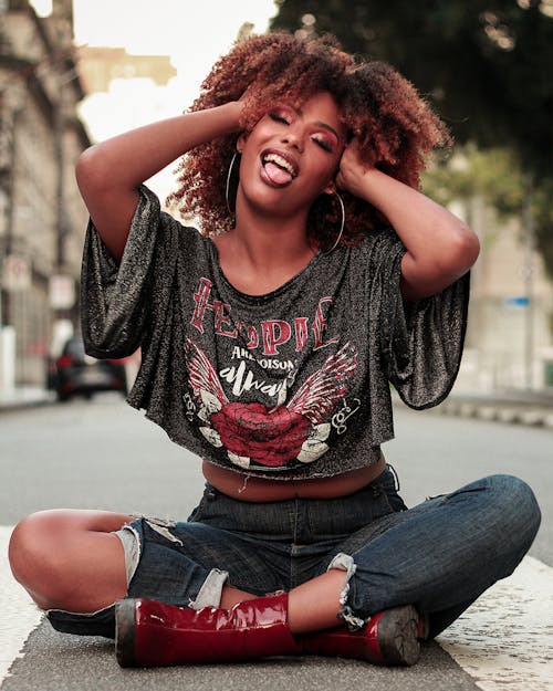 Free A Woman with Curly Hair Sitting on the Floor Stock Photo