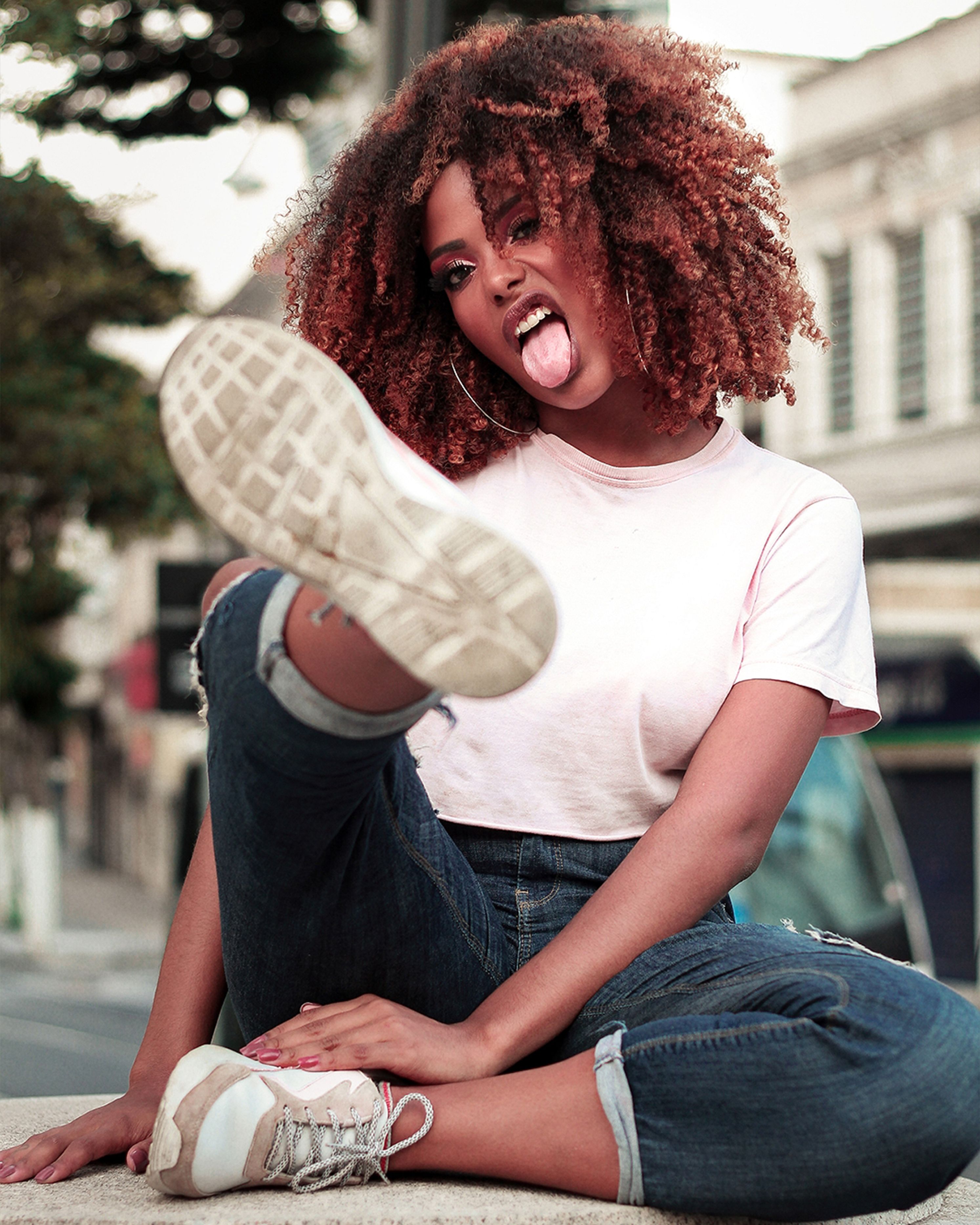 A Woman with Curly Hair Sitting on the Floor · Free Stock Photo