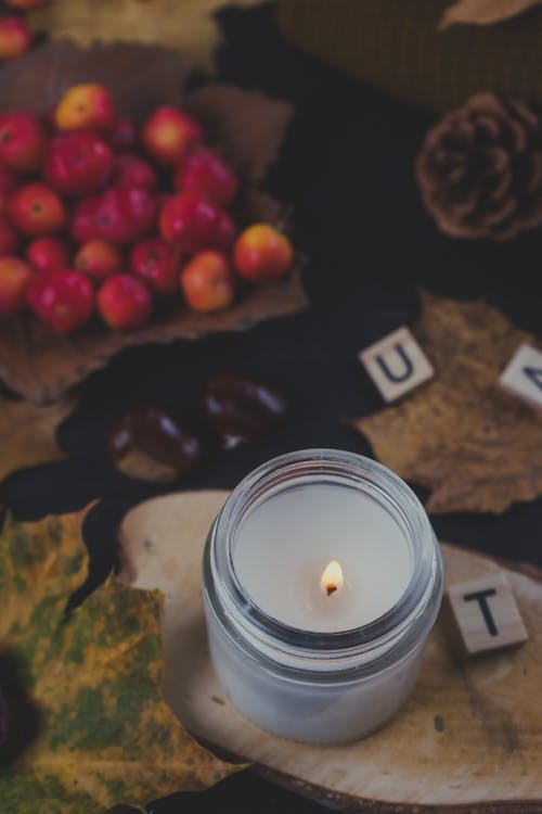 White Lighted Candle in a Glass Container