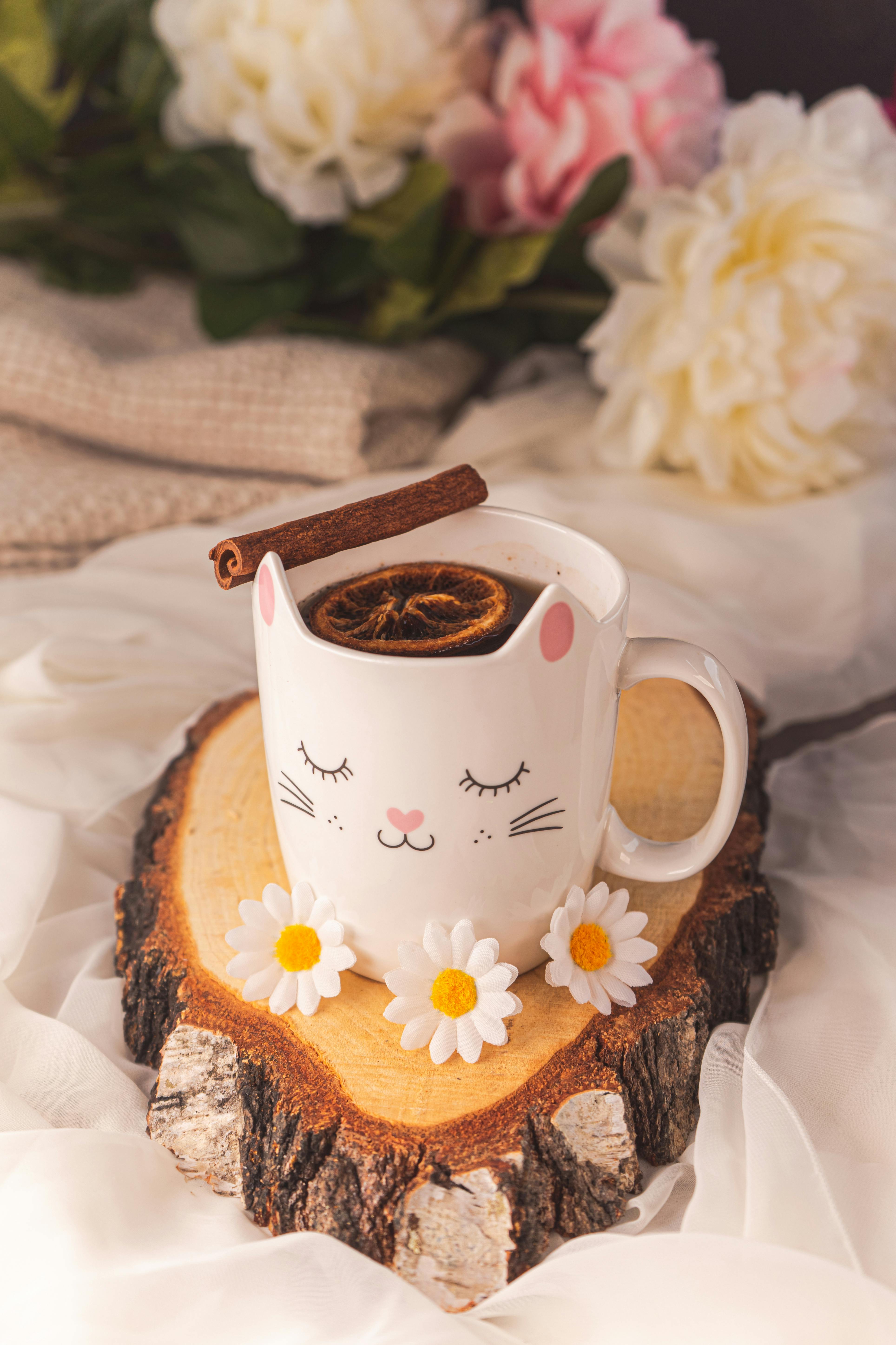 beverage in decorated cup on wooden tray