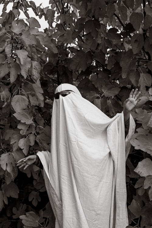Grayscale Photo of a Person in a Ghost Costume