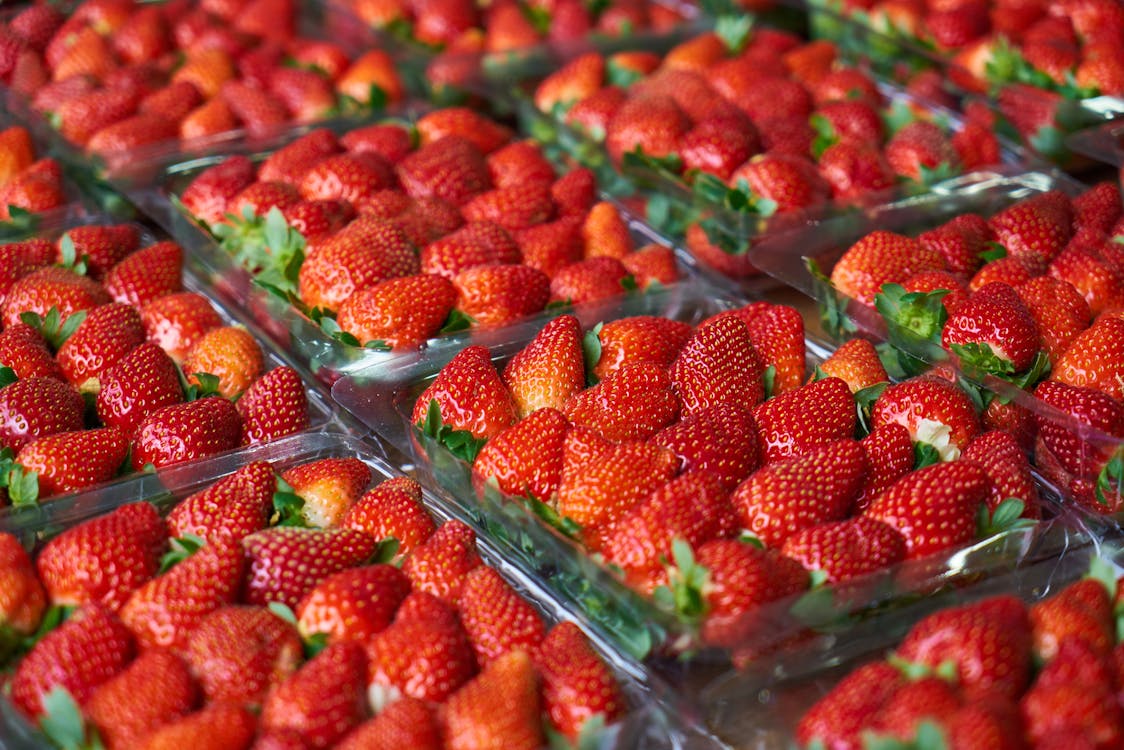 Close-Up Photo of Strawberries on Plastic Container