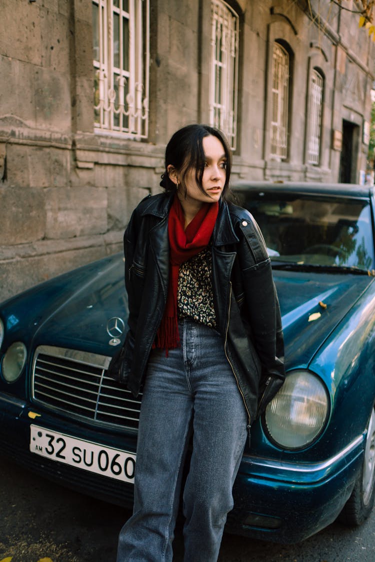 A Woman Leaning On The Car 