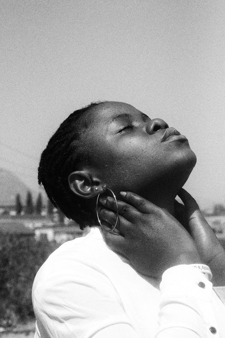 Grayscale Photo Of Woman In White Shirt Tilting Her Head Back