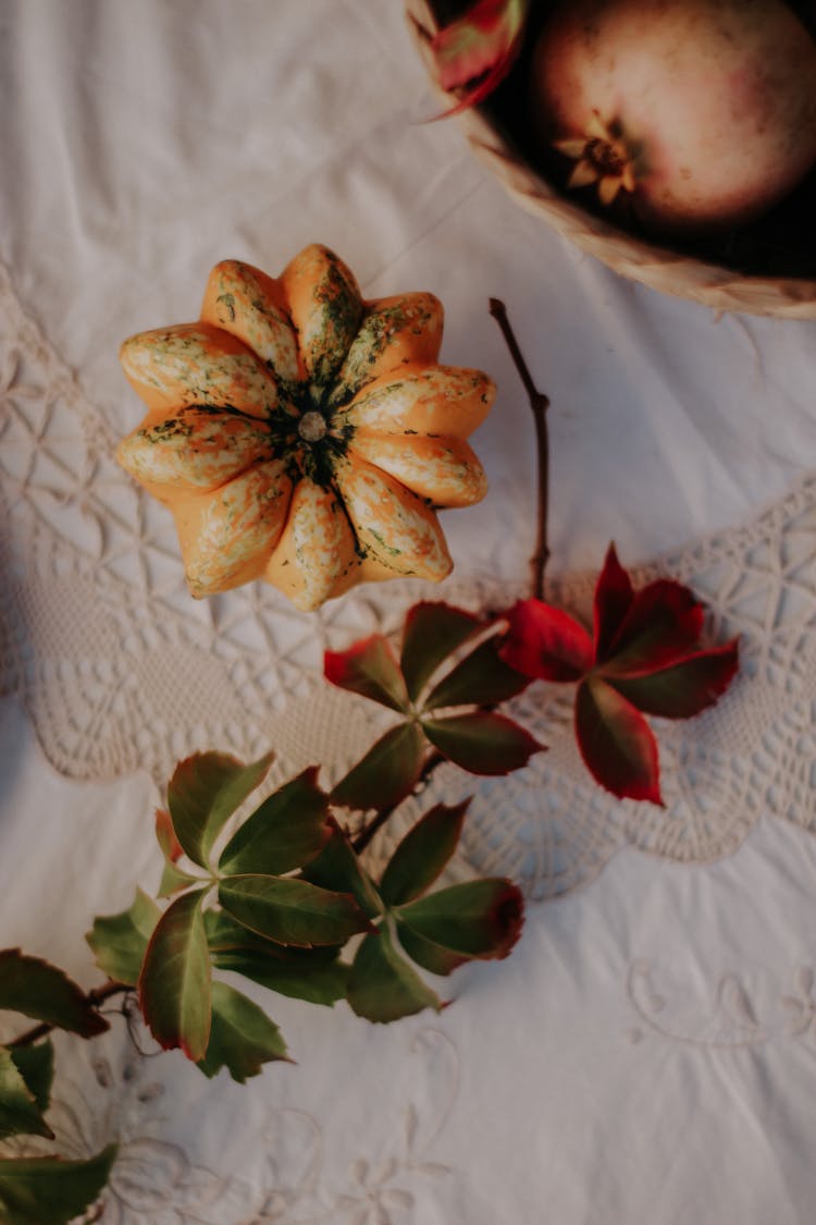 A Pumpkin On A White Table Mat