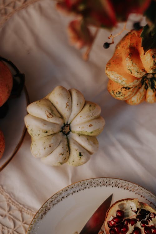 White and Orange Pumpkins on Table