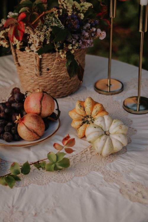 Free Rustic autumn table setting with gourds, pomegranates, and flower arrangement. Stock Photo