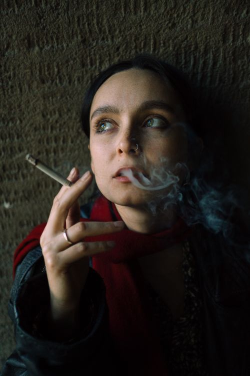 Woman with a Nose Piercing Smoking a Cigarette · Free Stock Photo