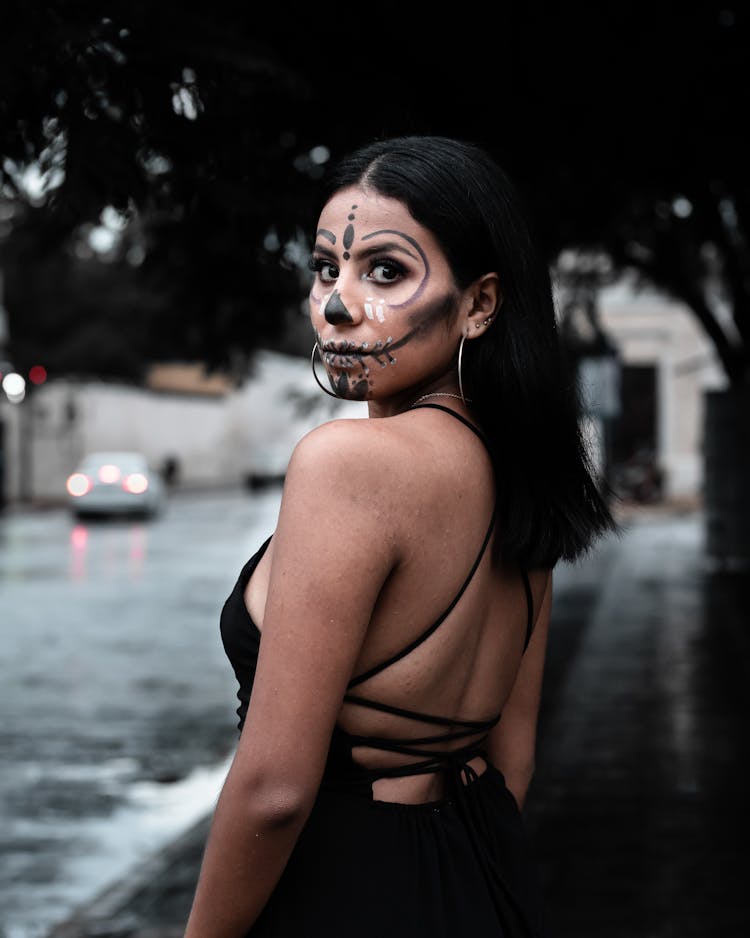 Portrait Of A Woman  With Face Paint Looking Over Her Shoulder