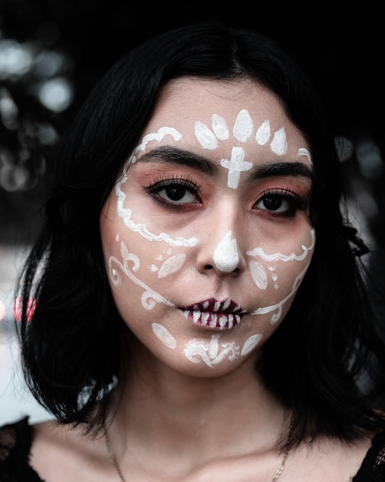 Portrait Of A Woman With White Face Paint On Her Face