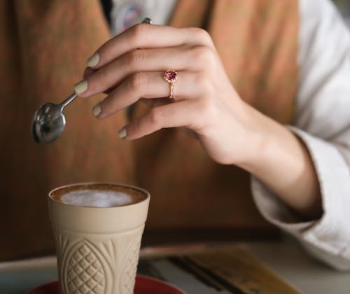 A Person's Hand Holding a Silver Spoon