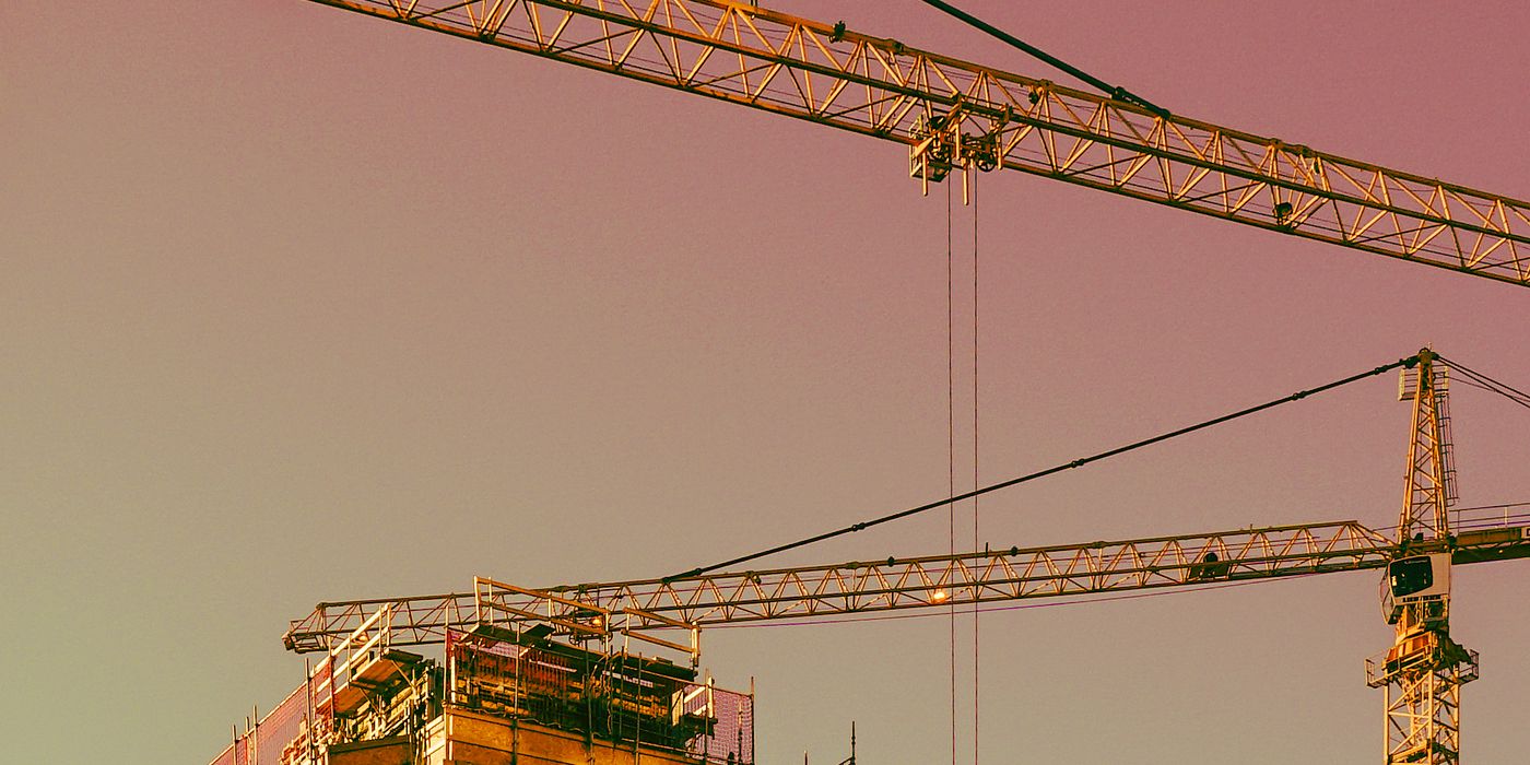 Construction crane above an unfinished building at a hotel development site