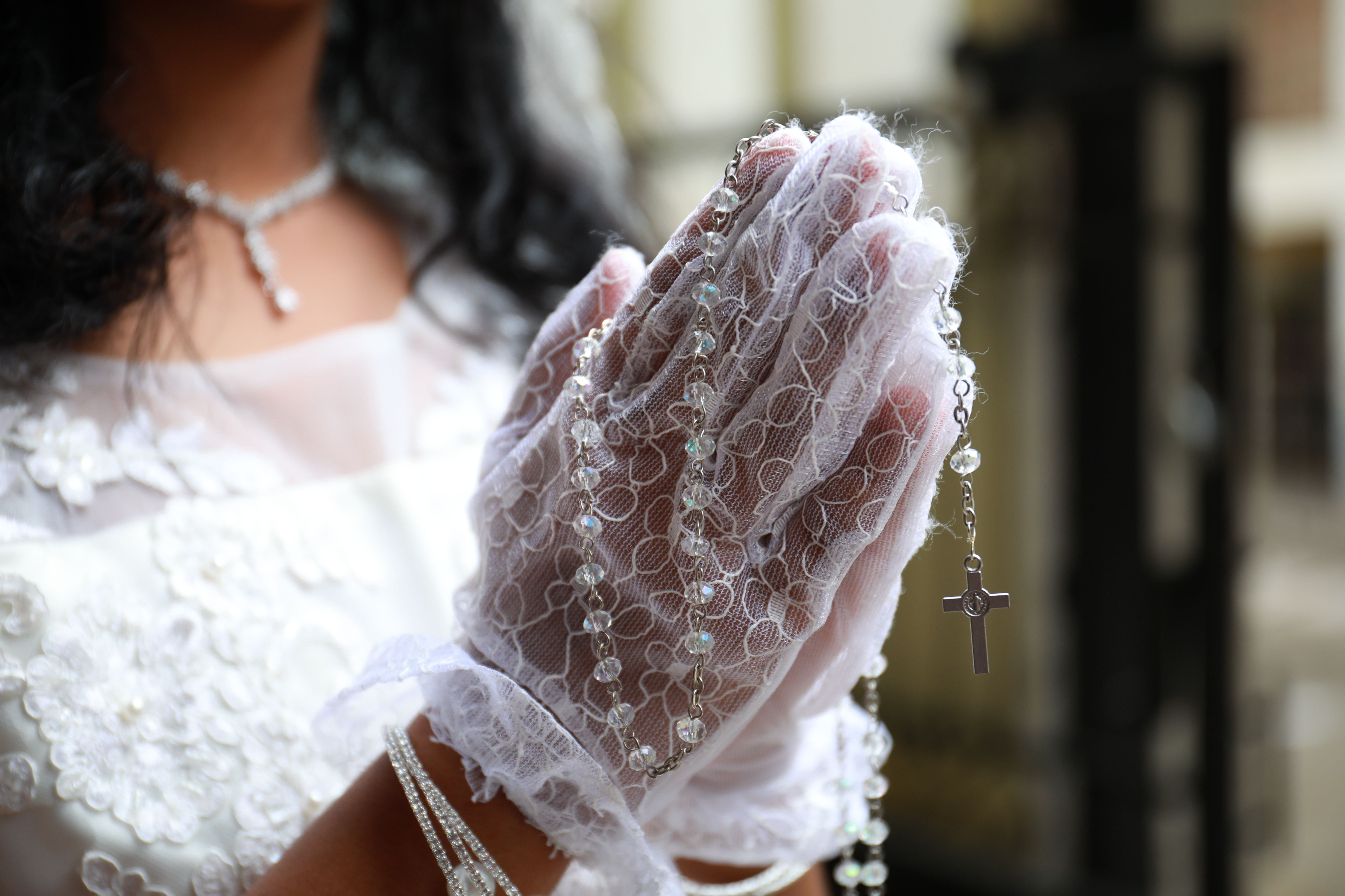 Woman Holding Prayer Beads in Clasped Hands · Free Stock Photo