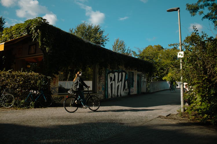 A Woman Biking On The Road