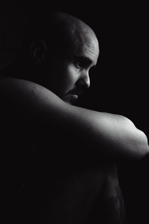 A Grayscale of a Bald Man