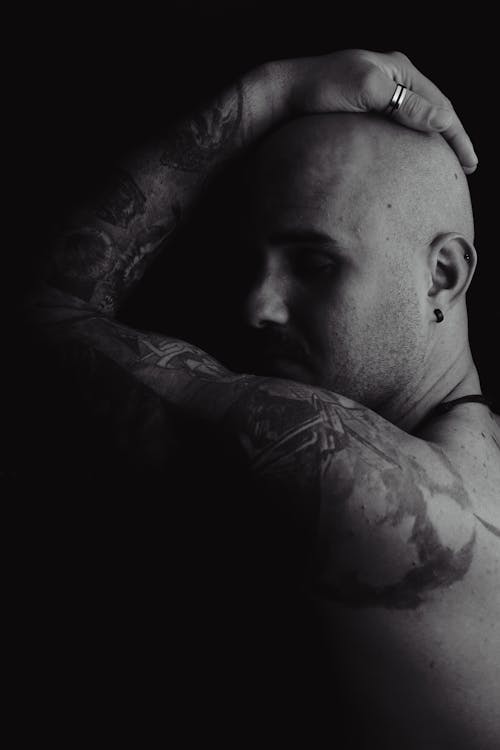Monochrome Photograph of a Man with Tattoos