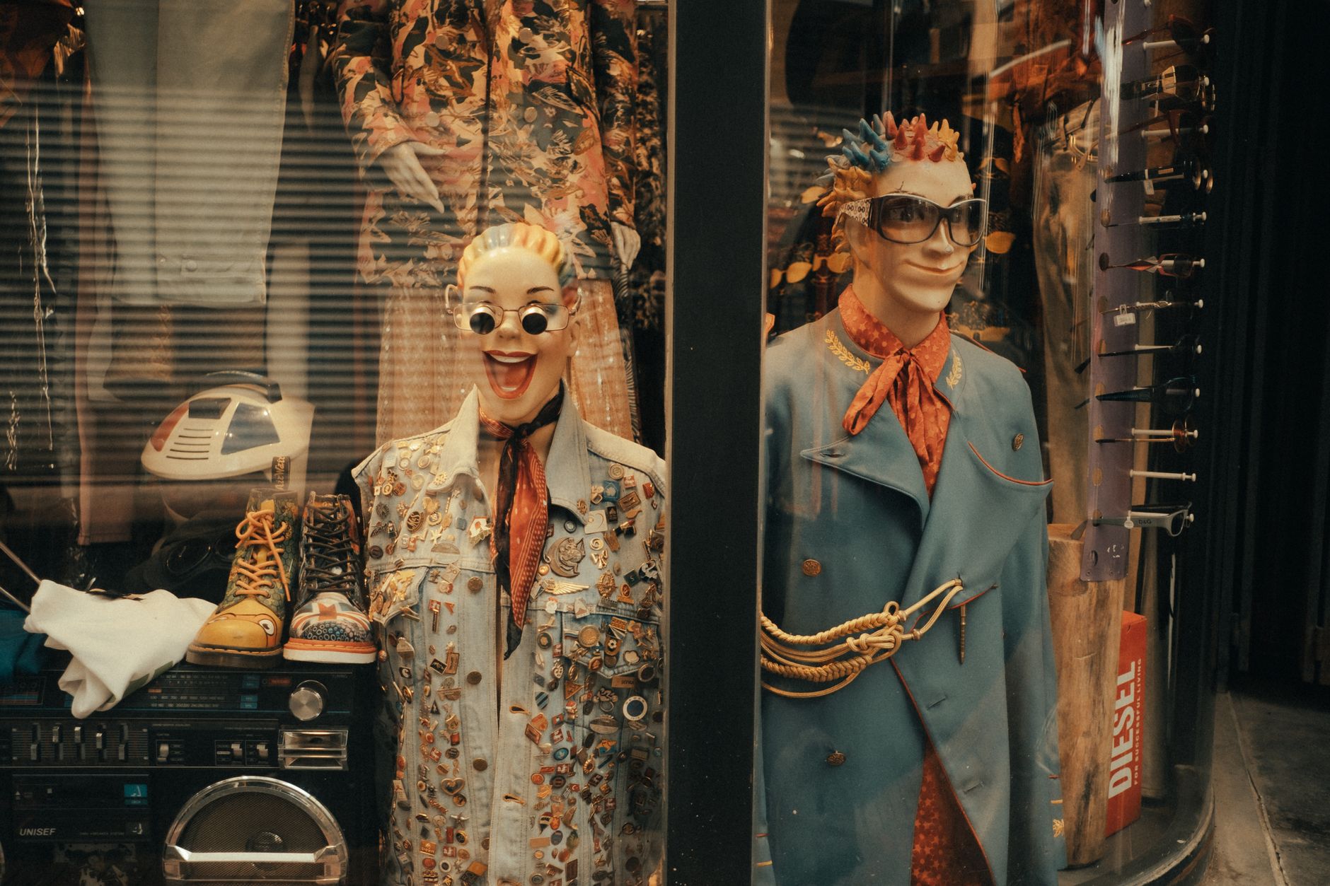 Vibrant, quirky mannequins in a retro window display showcasing eclectic fashion and accessories.