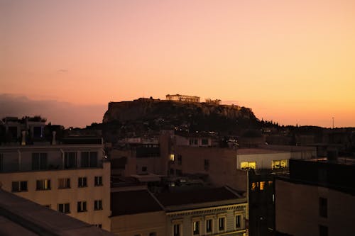 Ingyenes stockfotó alkonyat, domb, épületek témában