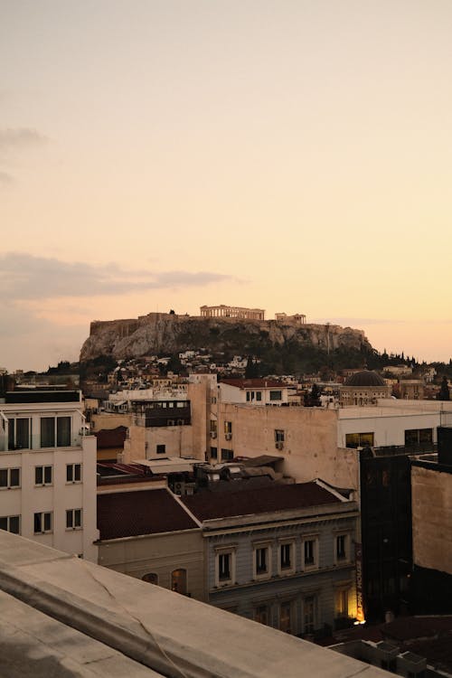 Roofs of Building in Town and Hill behind at Dusk