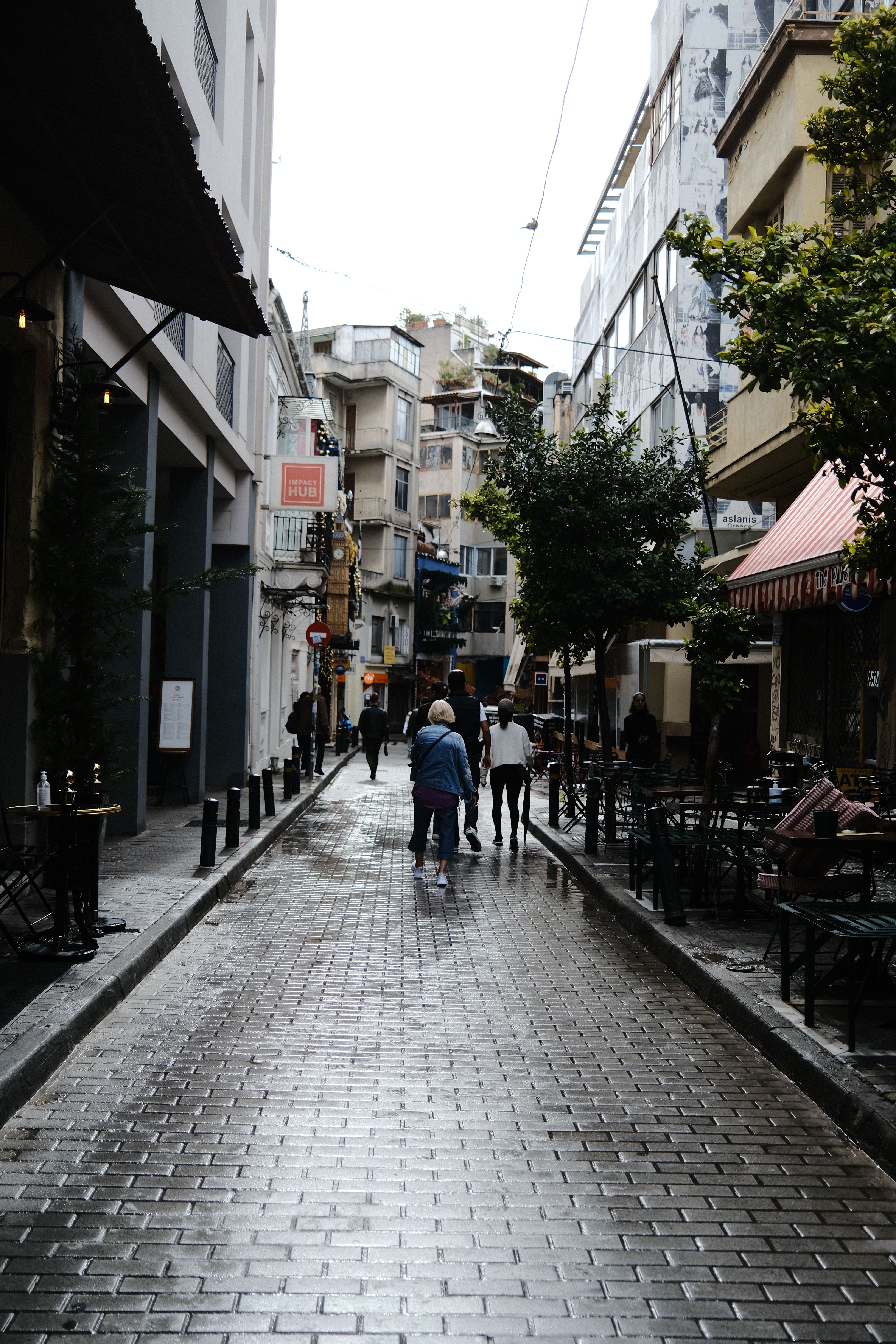People on a Narrow City Street between Buildings · Free Stock Photo