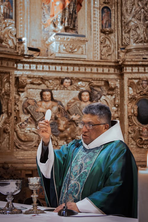 Priest with Host during Mass in Church