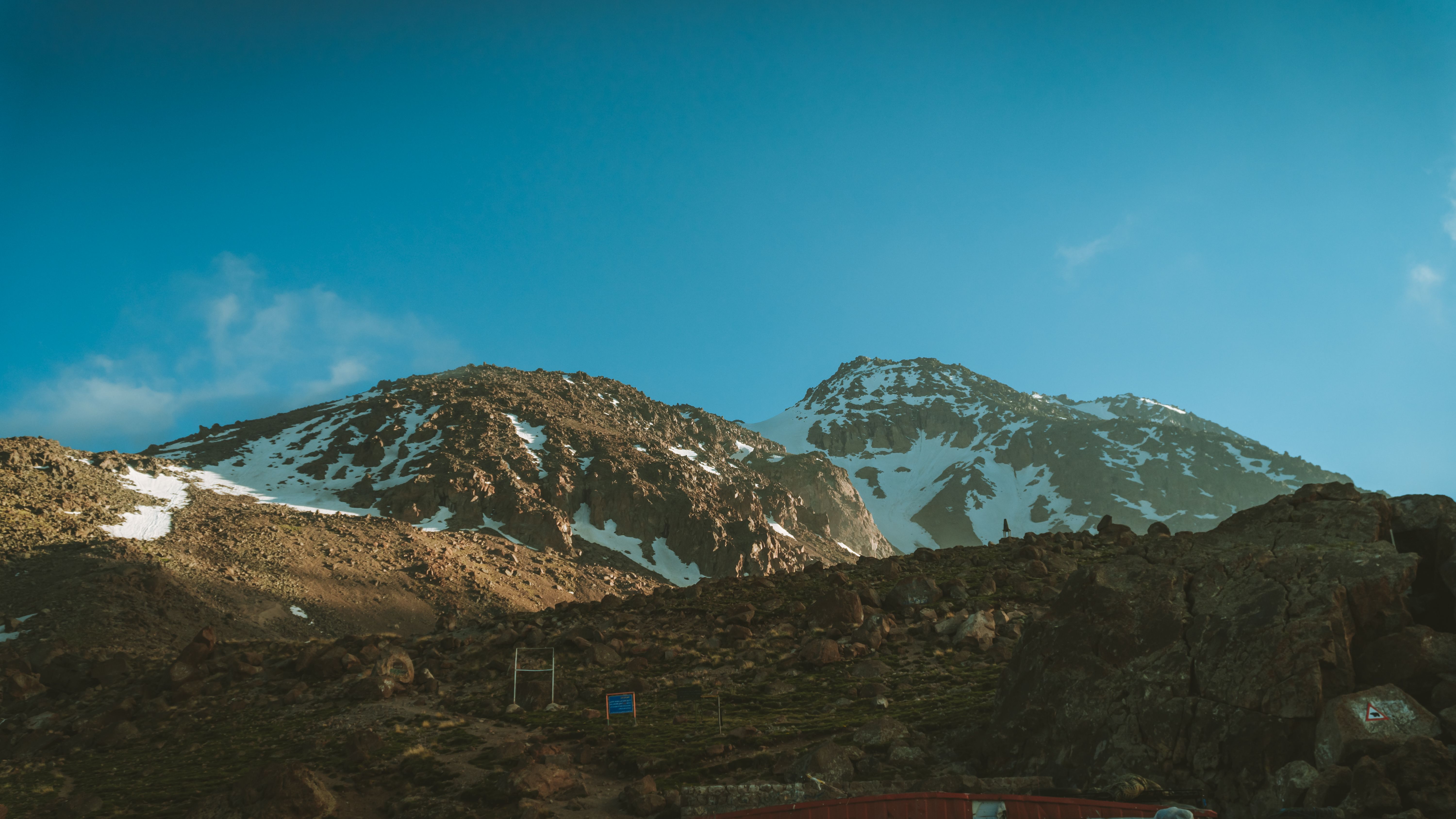 Brown and Black Rocky Mountain Under Blue Sky · Free Stock Photo