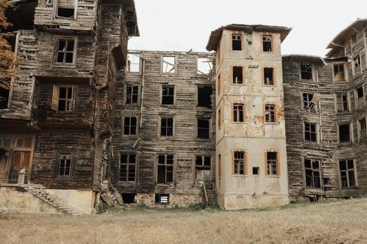 A decayed exterior of old wooden residential buildings showcasing urban decay and neglect.
