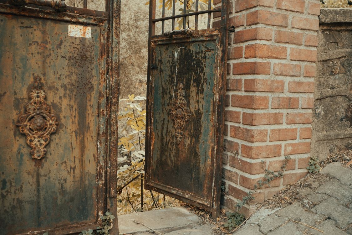 Rusty Metal Gate Beside a Brick Column · Free Stock Photo