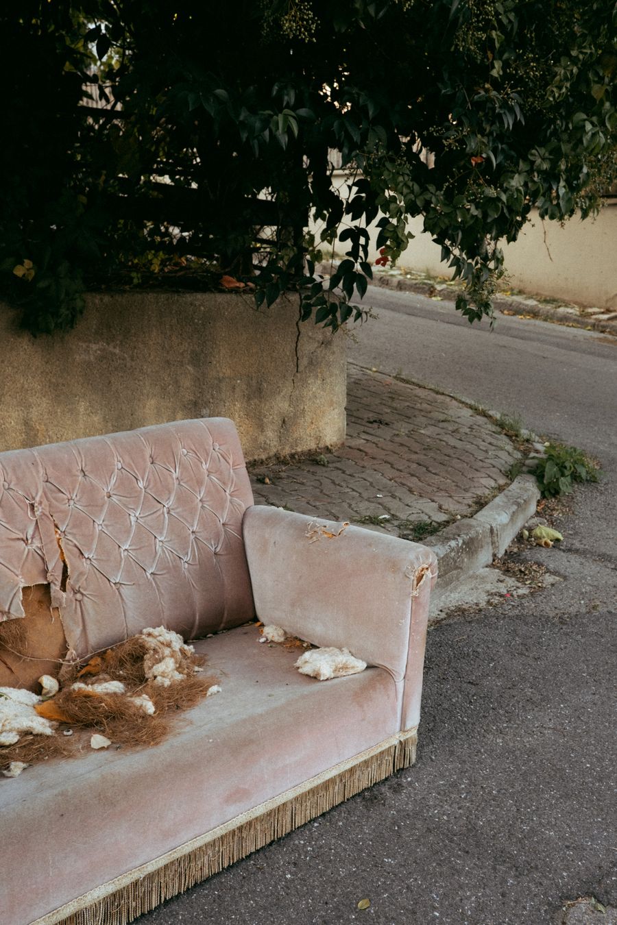 Old sofa waiting at the curb